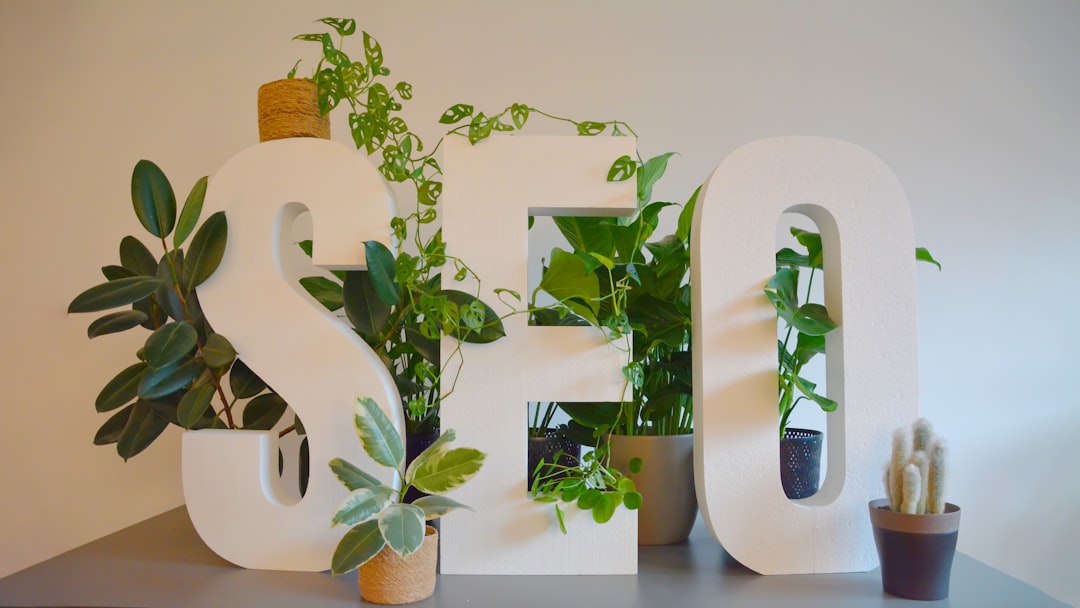 services-03 Vibrant and nature-inspired office setting at an SEO agency, featuring large 'SEO' letters prominently displayed on a modern desk. The letters are adorned with an abundance of lush green plants, creating a refreshing and natural atmosphere. The combination of digital focus and greenery brings a unique balance of productivity and tranquility to the workspace.